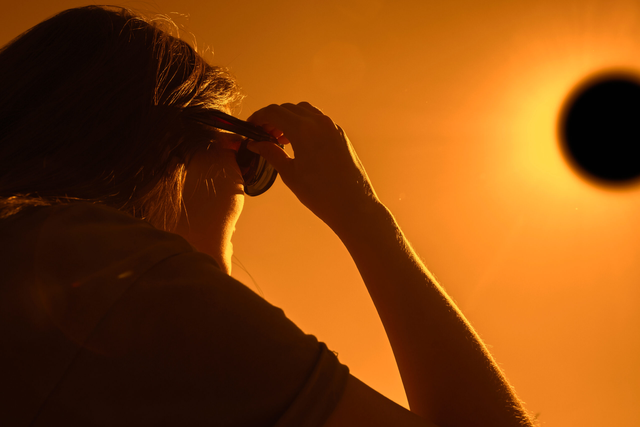 Woman Is Looking On solar Eclipse Through Three Sunglasses Sun - INNOCEAN UK 2024 APRIL REPORT